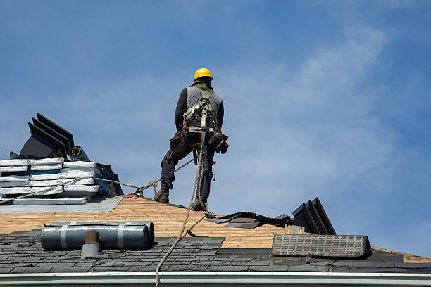 Professional Roof Replacement technician working in Wellington, MO